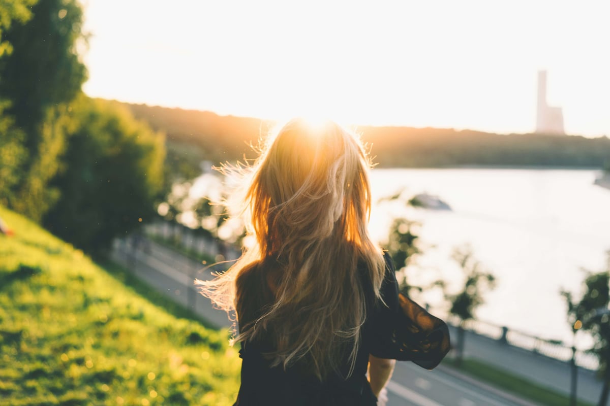 lady walking near water 